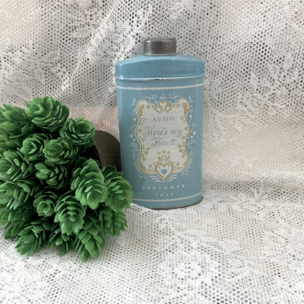Vintage 1970s Avon Heres My Heart Perfumed Talc Body Powder with some powder.